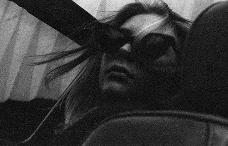 Moody black-and-white portrait — a figure behind sunglasses